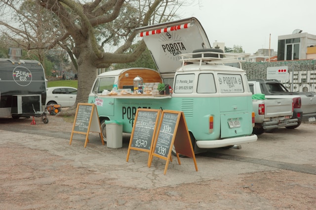 Wood-fired pizza food truck serving guests at an outdoor wedding