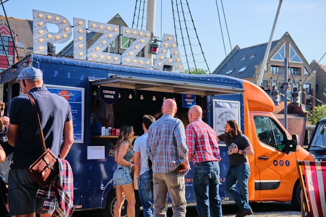 Employees gathering around a food truck at a corporate office event