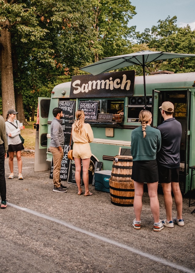Guests ordering food from a truck window at a catered event