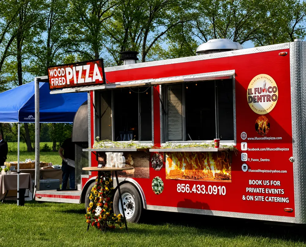 Il Fuoco Dentro, a wood-fired pizza food truck bookable in Philadelphia, set up at a catered private event