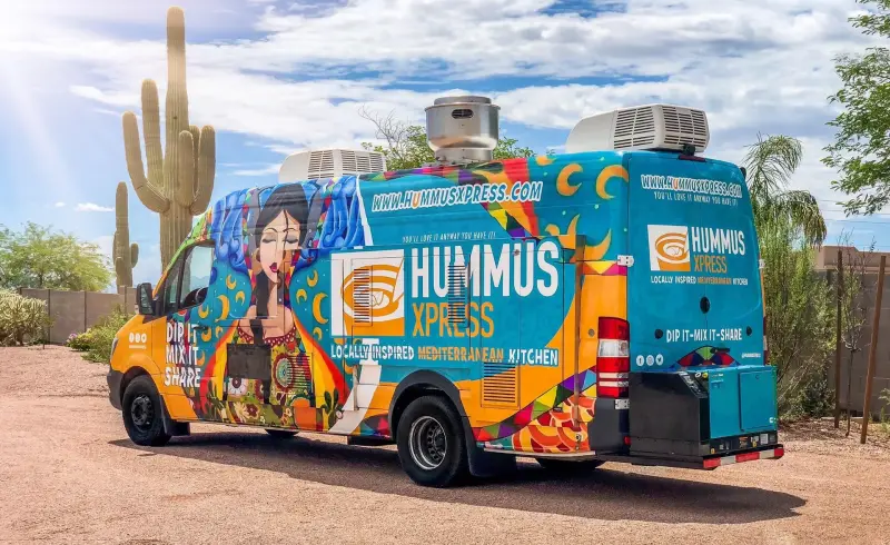 Food truck serving fresh dishes at an outdoor party event